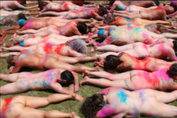 Naturists gather their bits and pieces to pose for a colourful photo in Canberra 